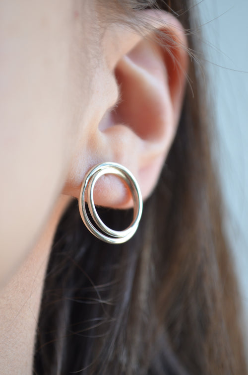 Close-up of a person wearing a silver handmade earring