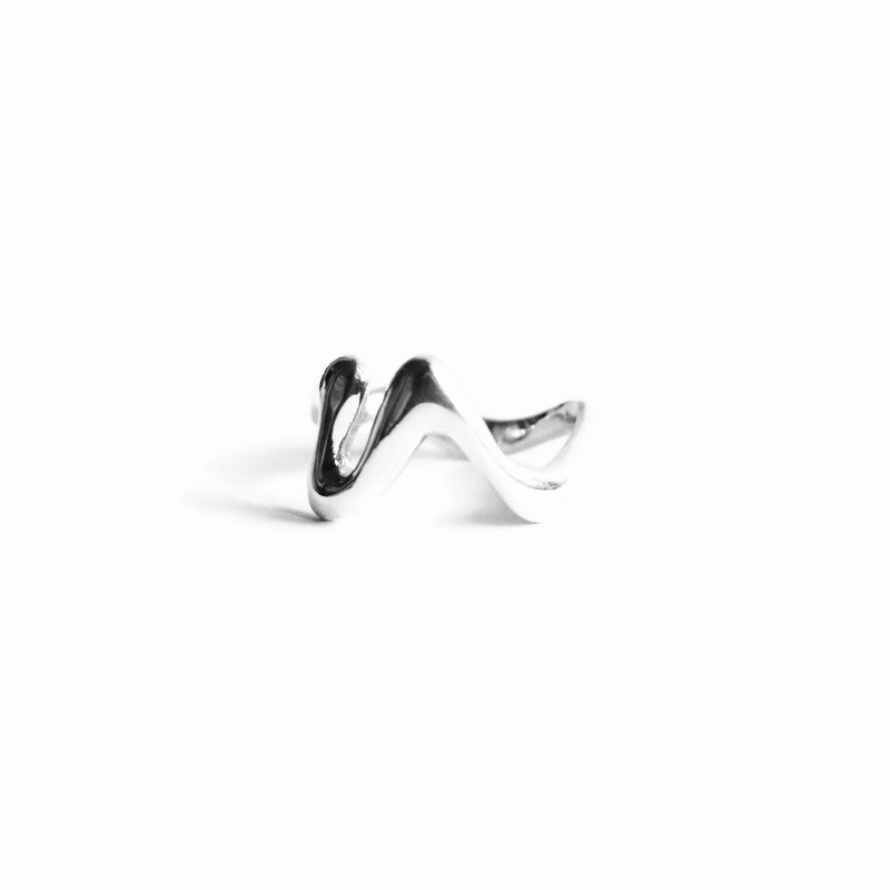 Silver ring with a wavy design on a white background